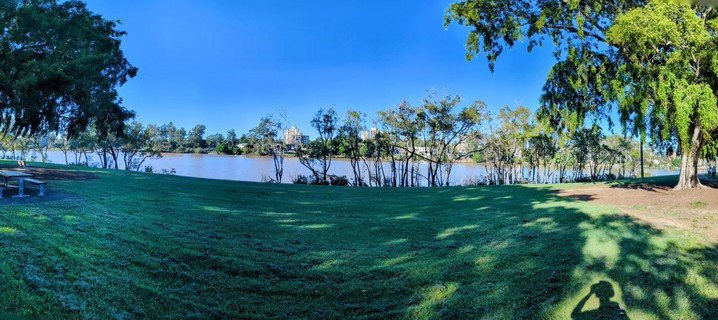 Panorama.
Grass. Gum trees. Wide river. Blue Sky. Dappled shade. Picnic bench.