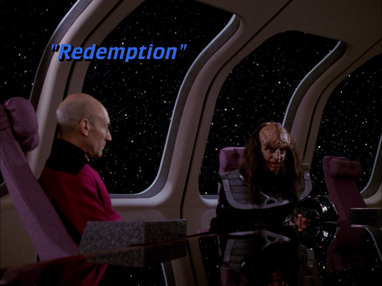 Patrick Stewart as Jean Luc Picard and Robert O'Reilly as Gowron, sat across a conference table aboard the USS Enterprise NCC-1701 D