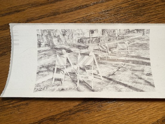 A photo of a thermal print from a toy camera using a shipping label as the media. 