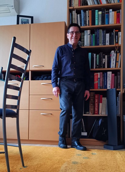 I'm modeling a new anthracite-colored cotton button-down shirt, standing in front of a bookcase in my home office. The shirt is advertised as a Japanese style, and it vaguely is.