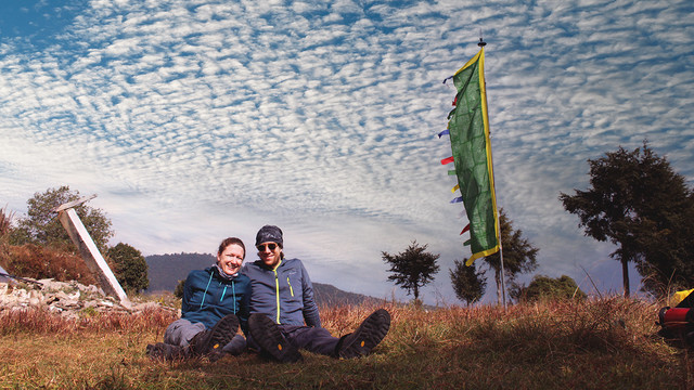 A couple (Respected guests) sitting on the grass field during Langtang Valley Trekking