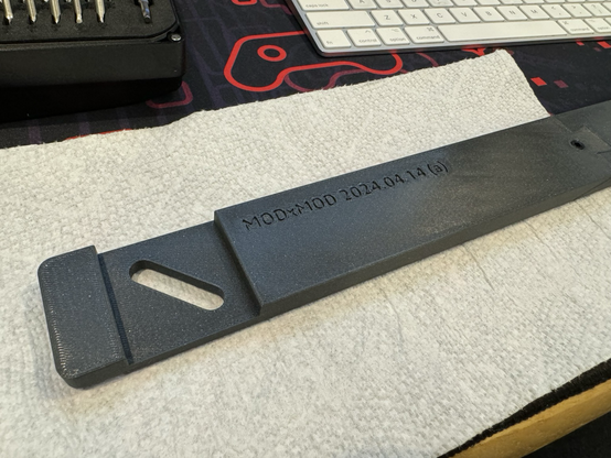 A 3D printed part with the word MODxMOD and today's date: 2024.04.14 
