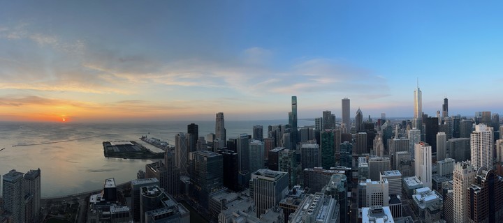 Chicago panorama at sunrise. Looking south, sun is on the left. Navy Pier on Lake Michigan. Some of the towering giants of Chicago (from left to right) include the new wavy St. Regis, the AON Center, Trump Tower, and Willis Tower (formerly Sears Tower). The picture was taken from the rooftop of Olympia Center at the intersection of Chicago Ave and Michigan Ave (Magnificent Mile)