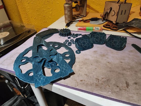 One side of a wheel structure with small gears attached and holes open around the outside