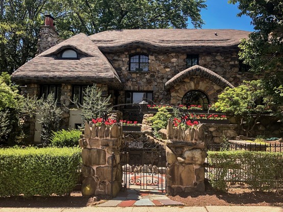 The Gingerbread house, a unique two-story stone house with a peaked brown roof