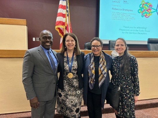 me (a white woman with brown hair and glasses, wearing a black jacket) with Pace Law Dean Horace Anderson (a Black man in a grey suit with blue shirt) and two of my CUNY Law colleagues Natalie Gomez-Velez (a Latinx Woman in black with a colorful scarf and glasses) and Andrea McArdle (a white woman with long brown hair in a patterned black dress )