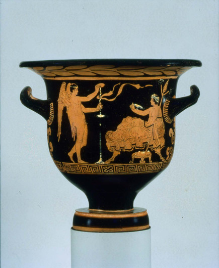 Red-figure vase painting of Eros, who adjusts a kottabos stand, and Dionysos, who reclines on couch, his lower body richly draped, holding a thyrsos in his left hand and a wine cup in his right.