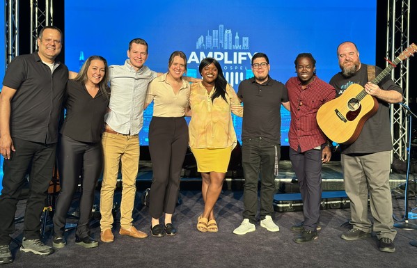 A team of praise musicians pose on the stage after the last program of a weekend convocation.