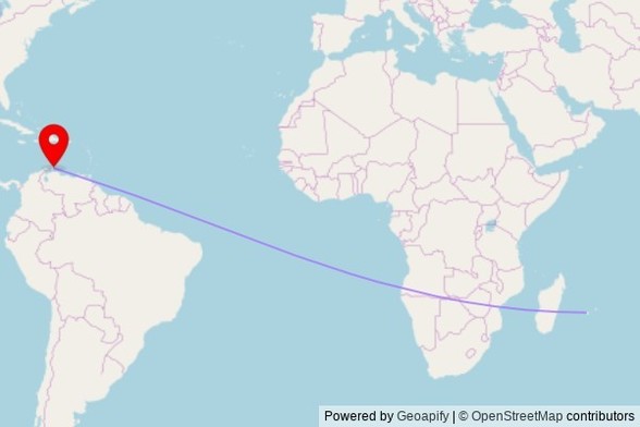 A map showing the great circle route from Le Port in France to a map pin at Holy Cross Anglican Church, Weg Sero Preto 31, San Nicolaas, Netherlands
