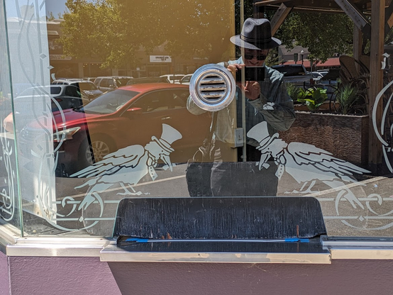 The ticket booth at the Raven theater/club/lounge/whatever shows two top-hatted ravens on its glass screen. They're facing each other, bowing politely. Yours truly is reflected in the glass.