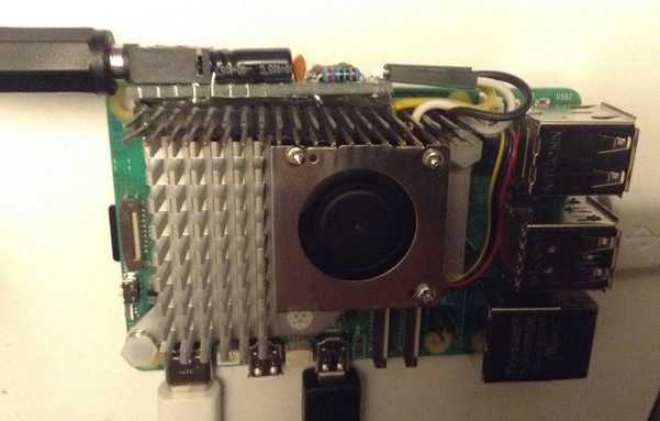 Photo of a Raspberry Pi 5 with the official cooler installed and a home made PWM output circuit hanging off a GPIO pin header socket.