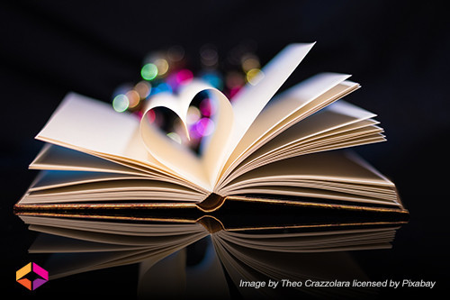Open book with pages forming heart shape.