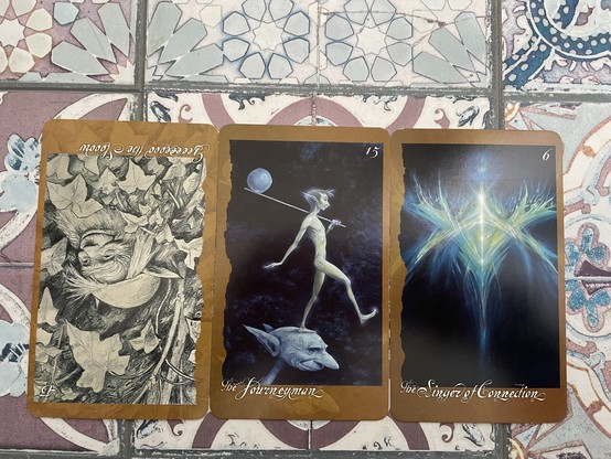 3 cards from Brian Froud’s Faeries oracle on a purple tiled floor. Each card shows a different faery