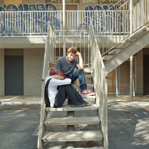 A colour film photo. Rigo and Sky are chilling out on an apartment staircase in East Austin, Texas. Wednesday, April 10, 2024.