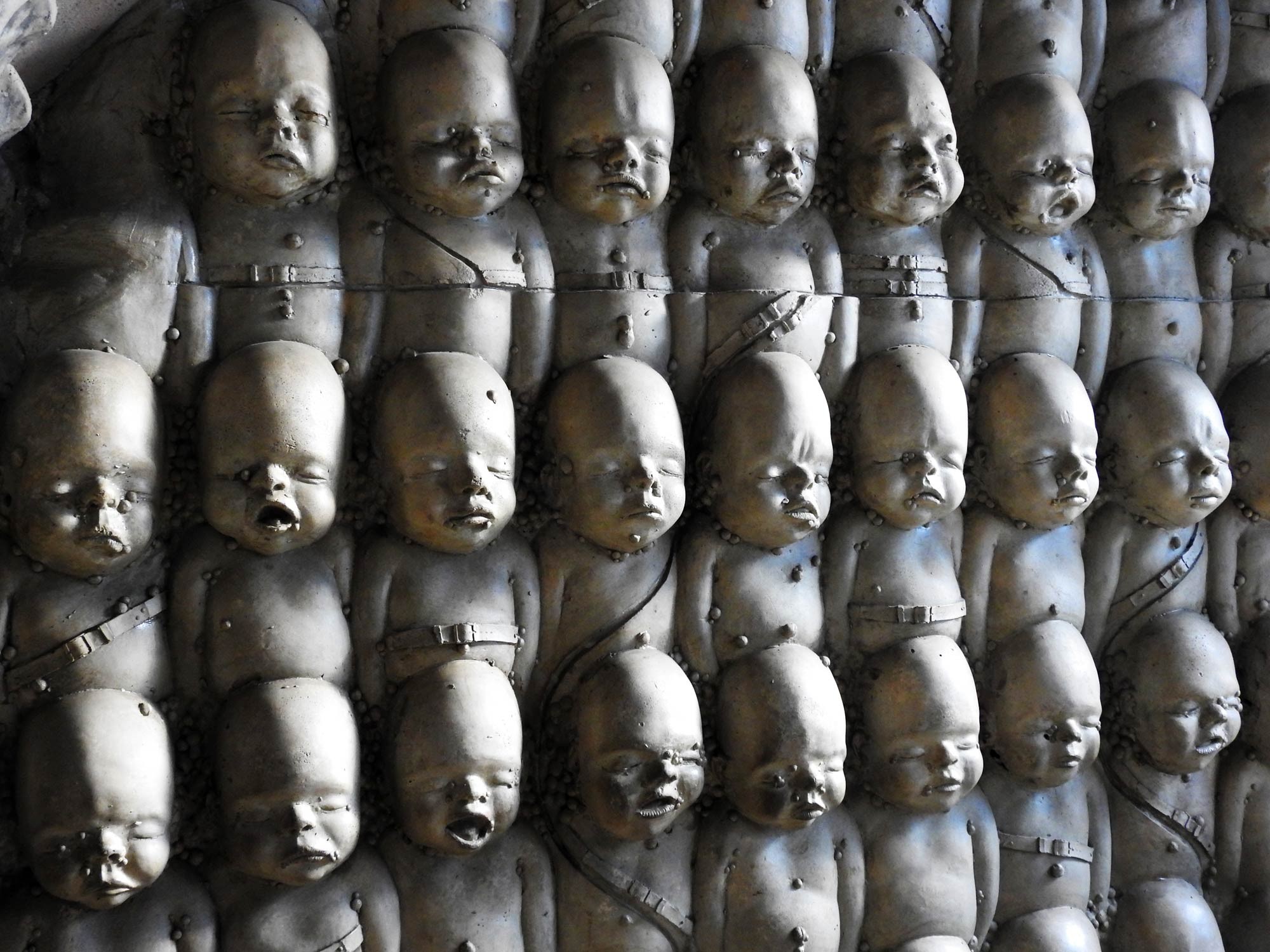 Photo of the bar wall designed by HR Giger. Looks like dead babies.