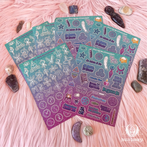 Six Spell Casting & Sigils Sticker Sheets are arranged on a faux fur backdrop. They are surrounded by a variety of rough, tumbled, and carved gemstones. There are three identical sheets of runes and sigils, and three identical sheets of witchy phrases and imagery. This is an exclusive product from Inked Goddess Creations.