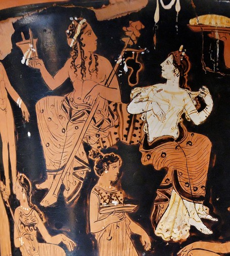 Red-figure vase painting of Dionysos and Ariadne sitting together, having a good time. Dionysos is holding his thyrsos, a staff tipped with a pine cone in his left arm and a kantharos cup in his right. He has long, curly hair flowing over his shoulders. Ariadne is looking at her husband with a smile, tugging at her transparent dress. She is wearing a crown, possibly the gift from Aphrodite.