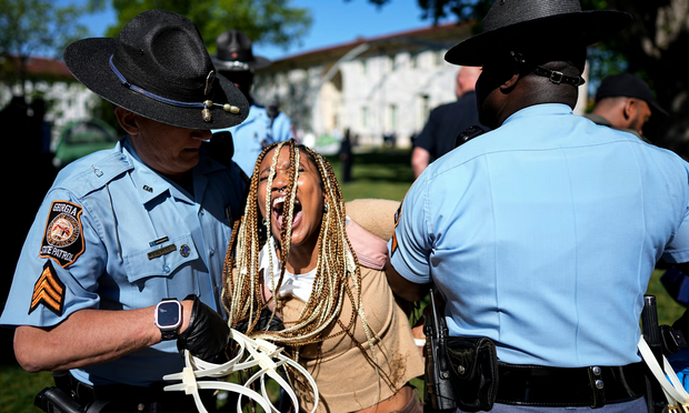 Georgia state patrol officers detain a demonstrator at Emory University on 25 April 2024. Photograph: Mike Stewart/AP