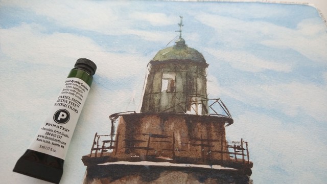 Tube of Daniel Smiths paint "green apatite genuine" in front of the top of the lighthouse.