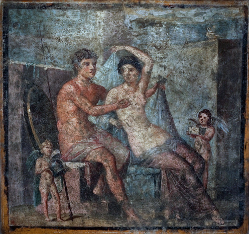 Fresco of Mars and Venus. Mars is depicted as a youthful, beardless man, fondling her breast and taking off her clothes. Bejewelled Venus takes off her clothes as well, turning towards him. Two of their winged children are there with them, one holding Mars' spear and helmet, the other holding a box.
