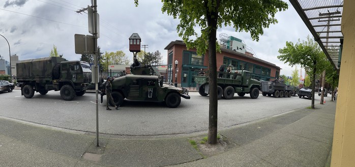 A caravan of military style vehicles in the street in Vancouver waiting for a movie shot.