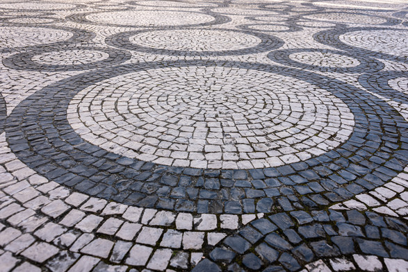 A photograph of calçada Portuguesa in the shape of many circles
