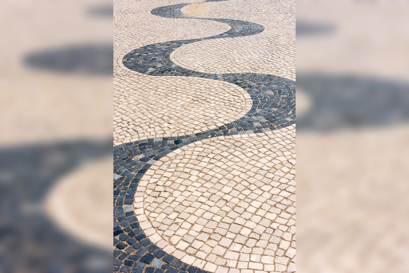 A photograph of calçada Portuguesa in the style of a continuous undulating wave