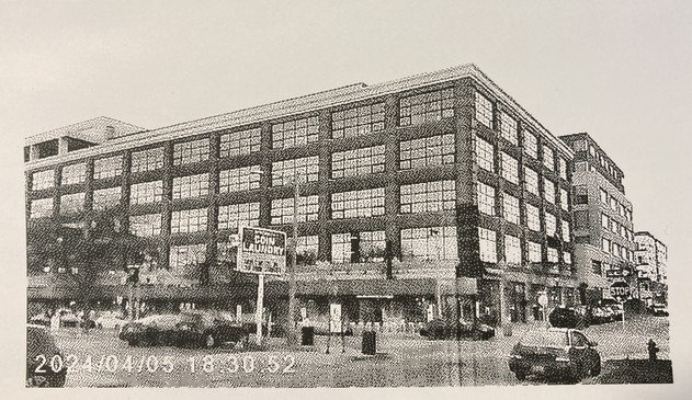 A low resolution photo printed on thermal paper showing a building.