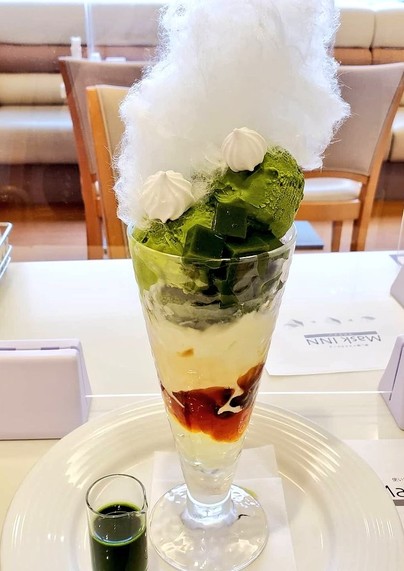 Matcha parfait topped with a cloud of cotton candy.