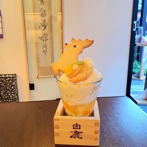 Peach parfait topped with a leaping deer biscuit.