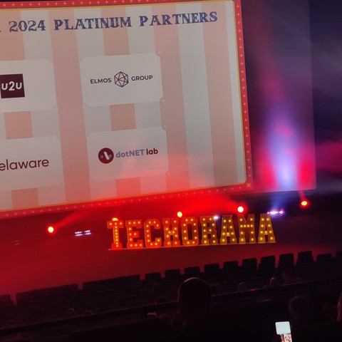 One of the speaker stages, with a big Techorama sign, in a theme park style font with lightbulbs on it.