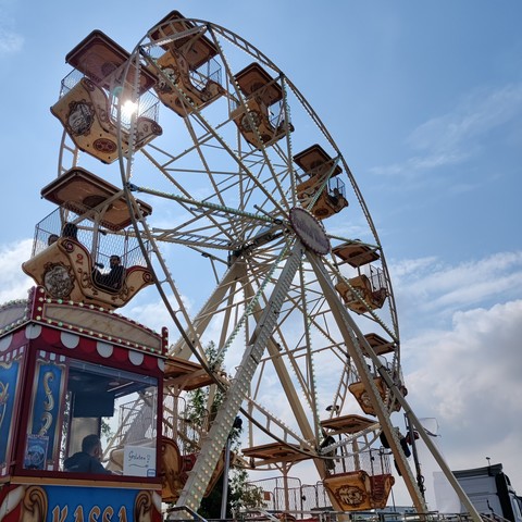 A Ferris wheel outside the venue, shot against a blue sky.