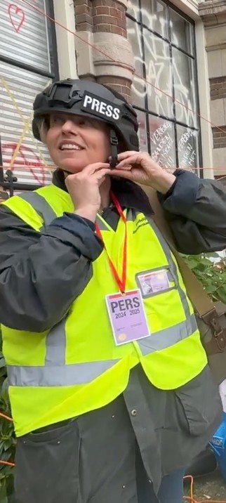 ALT TEXT 
Amsterdam - journalist (me) fixing head protection during Police raid.