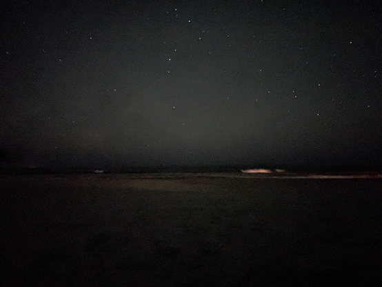 Photograph taken around midnight at Folly Beach, South Carolina. The photo is enhanced to show the stars in the sky, and the beach as well. 