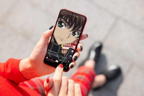 A woman looks at her phone, which has a TikTok of the I'm At Soup meme video playing.