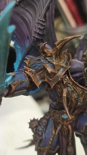 Photo of a warhammer 40k nurgle demon prince painted up in a death knight inspired colour scheme showcasing bronze painted in nmm style but with actual metallic paints focused on right shoulder
