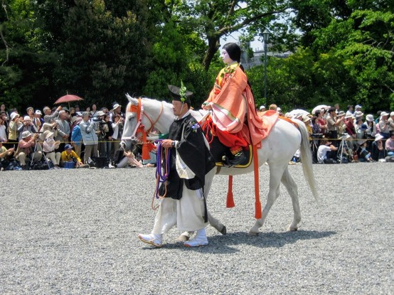 A horse is led in procession in the grounds of the Imperial Palace at the start of the Aoi Festival.