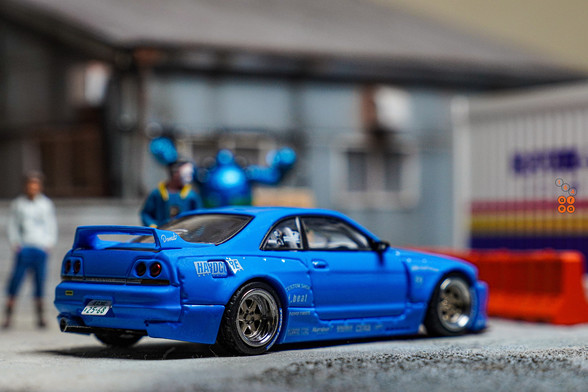 A right side of Nissan Skyline GT-R (R33), Rocket Bunny, Blue by INNO64 in 1:64 scale with 1:64 figure on AREA 164