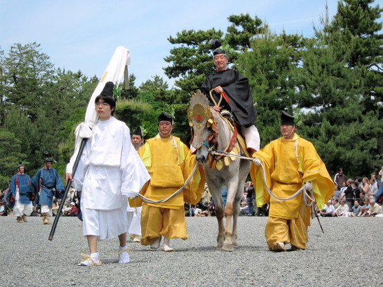 Attendants lead a horseman during the Aoi Matsuri parade.