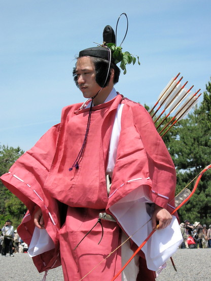 An archer at the Aoi Matsuri parade. His hat is adorned with wild ginger.