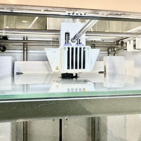 halfway through printing a black kuksa in the 3d printing machine