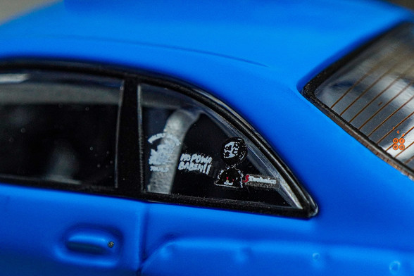 A close-up shot of Nissan Skyline GT-R (R33), Rocket Bunny, Blue by INNO64 in 1:64 scale with 1:64 figure on AREA 164