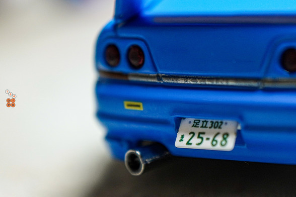 A close-up shot of Nissan Skyline GT-R (R33), Rocket Bunny, Blue by INNO64 in 1:64 scale with 1:64 figure on AREA 164