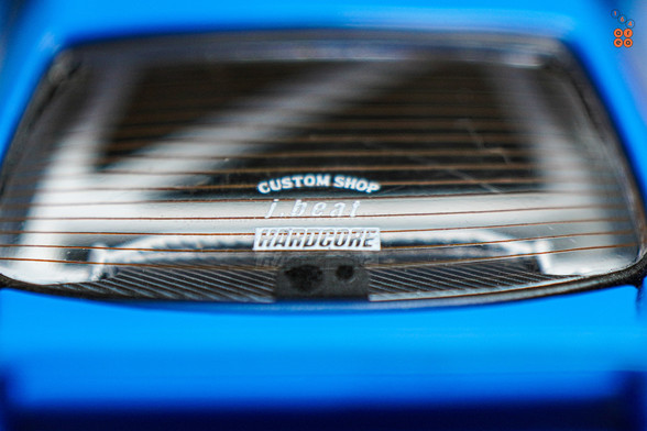 A close-up shot of Nissan Skyline GT-R (R33), Rocket Bunny, Blue by INNO64 in 1:64 scale with 1:64 figure on AREA 164