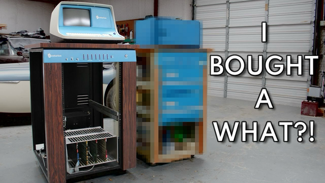 A closer photo of an unloaded Centurion Mini Computer with a terminal on top, in a garage. Photo is definitely a thumbnail from Usagi Electric on youtube.