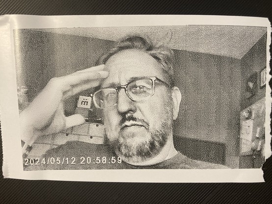 A self portrait taken with a toy camera that prints on thermal paper. 