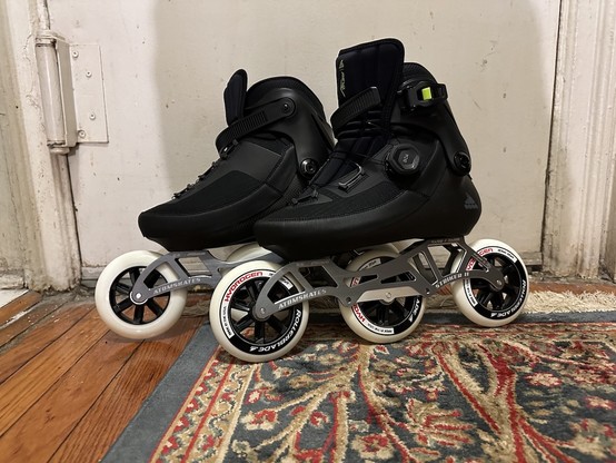 Photo of a pair of pristine inline skates. Rollerblade Revv BOA boots mounted on convertible with Luigino Stryker frames with RB Hydrogen 3x110mm wheels.