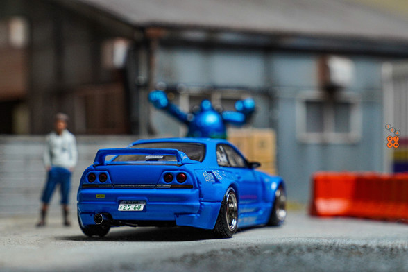 A rear view of Nissan Skyline GT-R (R33), Rocket Bunny, Blue by INNO64 in 1:64 scale with 1:64 figure on AREA 164