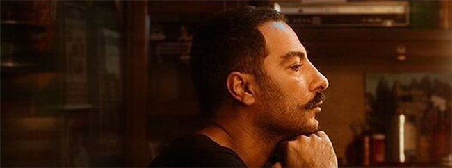 The promotional poster for Actor shows Ali sitting in front of his mirror in his dressing room, his chin resting on his hands, and calmly looking at his reflection (which is off-camera for us).