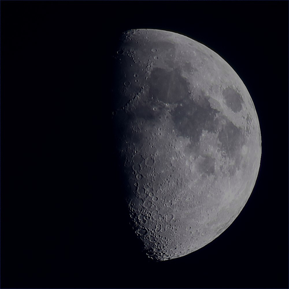 The Moon at waxing gibbous phase on a dark background. 